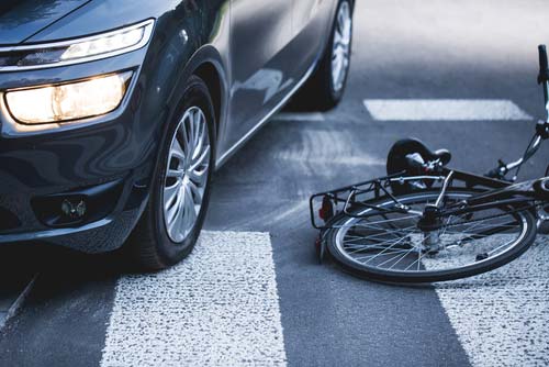 a bicycle hit by a car, Delray Beach bike accident lawyer concept