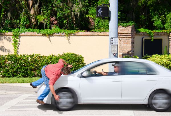 A man getting hit by a car that needs to call a Pedestrian Accident Lawyer in Palm Beach Gardens