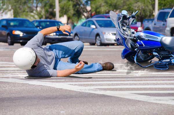 A man thrown off a motorcycle hit by a car