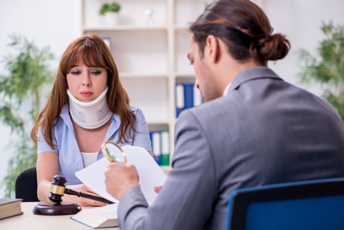 Woman with neck brace meeting personal injury lawyer in Jupiter Florida