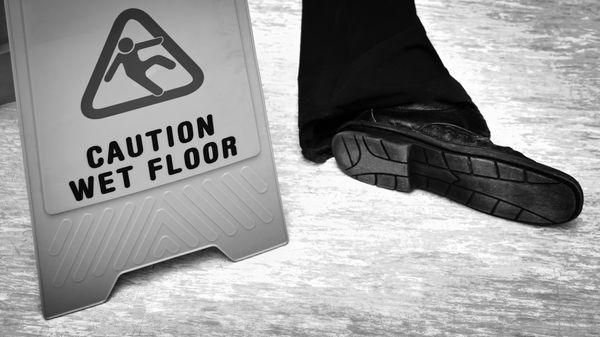 A man who has fallen and needs to call a Slip and Fall Lawyer in West Palm Beach